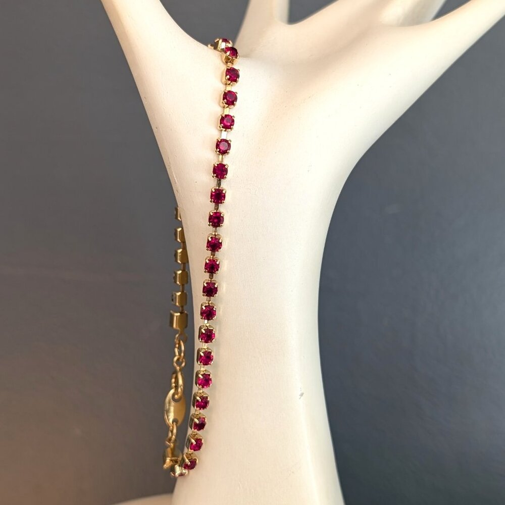 Avon faux ruby and gold tone tennis bracelet